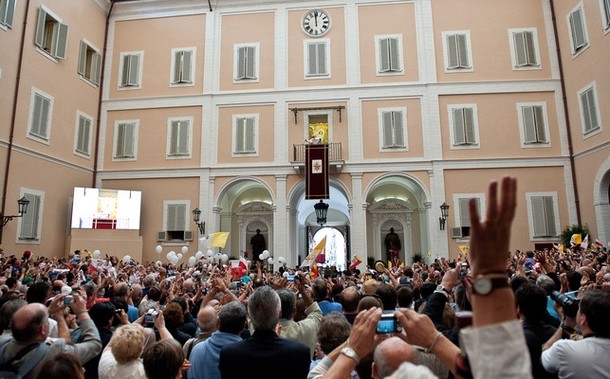 Pope Benedict XVI waves to pilgrims gath